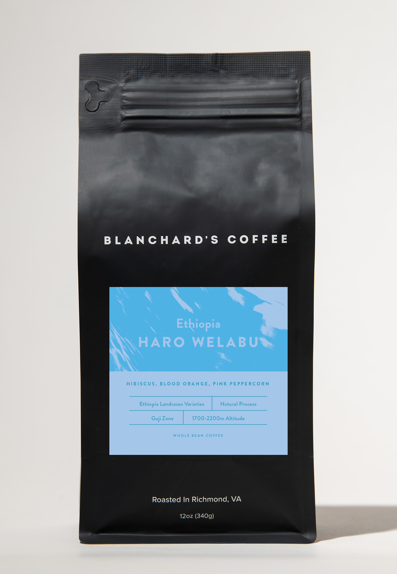 A white bag of coffee beans from Rosso Coffee Roasters